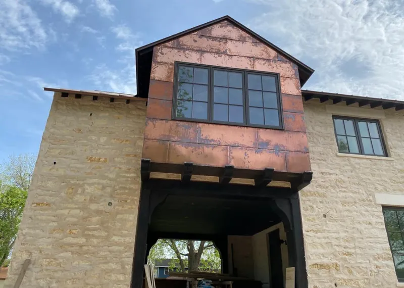 Copper metal panel facade on a stone building for Skylight Installation in Millstone